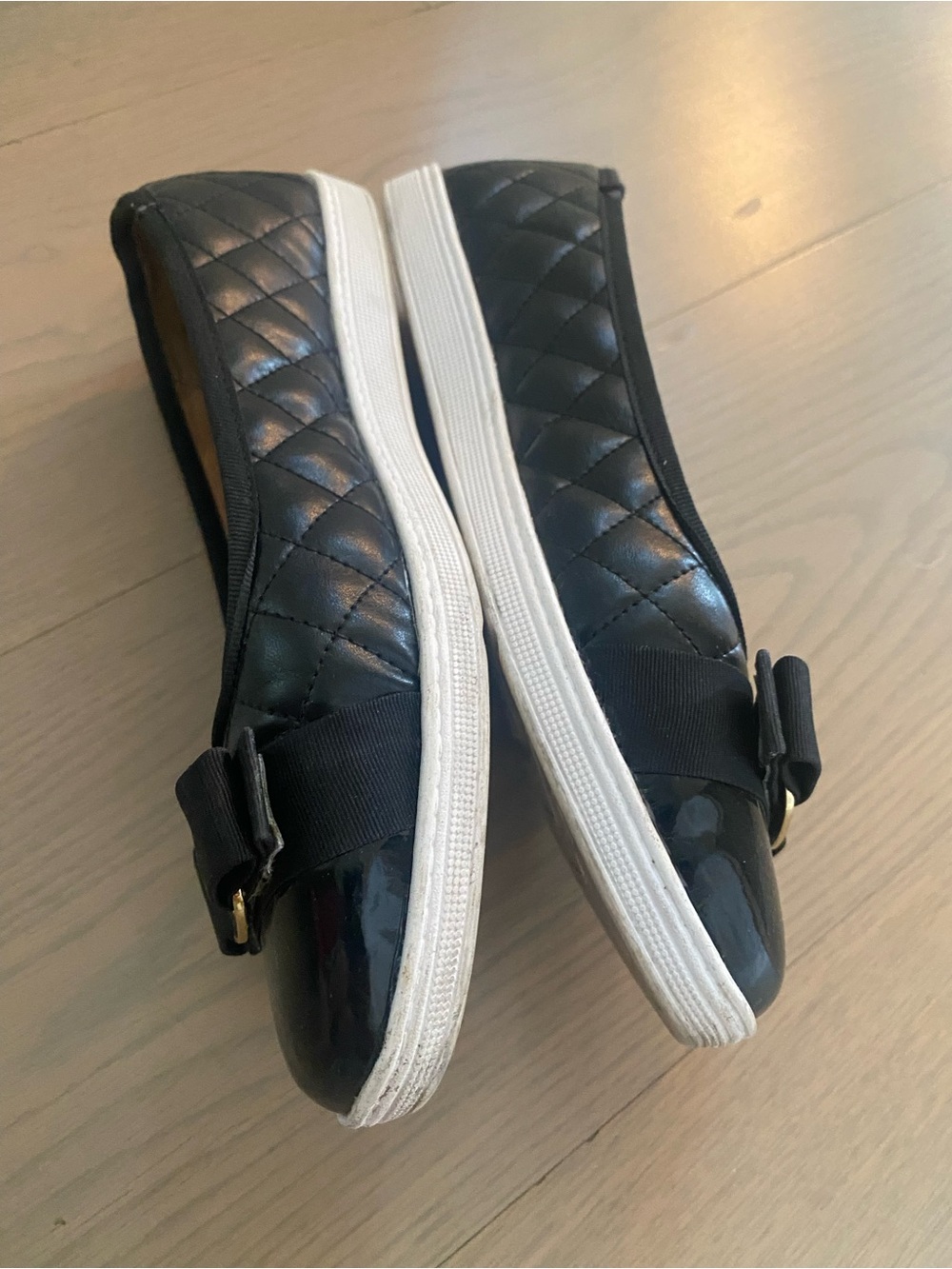 Quilted Black Slip-On Women's Sneakers with Bow Accent
